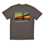 Gray t-shirt with a graphic of a bridge and sunset on the back, on a white background