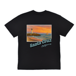 Black t-shirt with a scenic print of Santa Cruz, California featuring a lighthouse and beach.