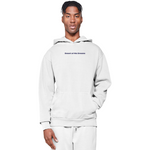 Person wearing a white hoodie with text on a white background