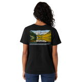 Person wearing a black t-shirt with a scenic design on the back