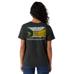 Person wearing a black t-shirt with a scenic print on the back