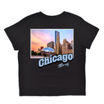 Black t-shirt with a graphic of Chicago skyline and 'Chicago Illinois' text on a white background