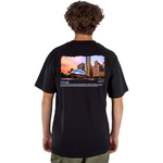Person wearing a black t-shirt with a cityscape design on the back