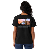 Person wearing a black t-shirt with a cityscape design on the back