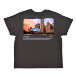 Black t-shirt with a graphic of the Chicago skyline and Bean sculpture on a white background