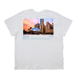 White t-shirt with a graphic of Chicago's skyline and Bean on the back.