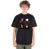 Person wearing a black t-shirt with a graphic design on a white background