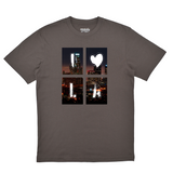 Gray t-shirt with a graphic design of a city skyline and heart on a white background