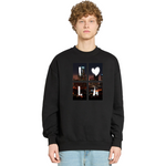 Person wearing a black sweatshirt with a cityscape design on a white background