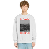 Person wearing a sweatshirt with 'Los Angeles California' text and graphic