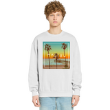 Person wearing a light gray sweatshirt with a Malibu design featuring palm trees and a sunset.