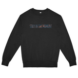 Black sweatshirt with 'STAY IN THE MOMENT' text on a white background