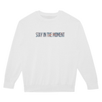 White sweatshirt with 'Stay in the Moment' text on a white background