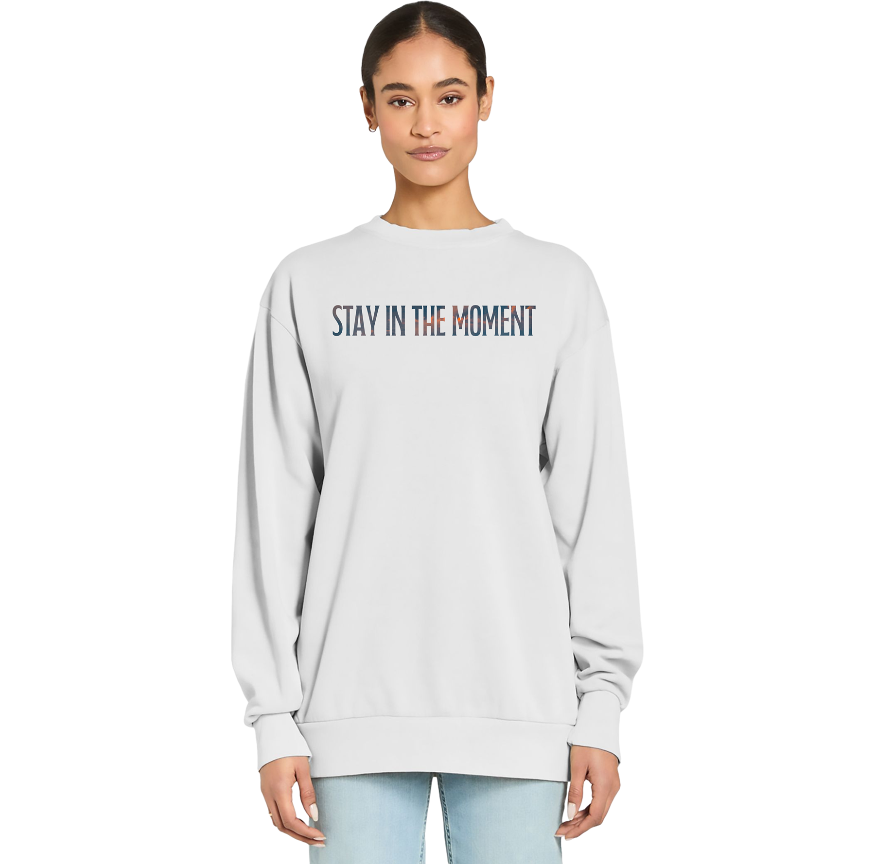 Person wearing a light gray sweatshirt with 'Stay in the Moment' text on a white background