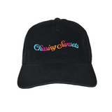 Black cap with 'Chasing Sunsets' text in colorful letters on a white background