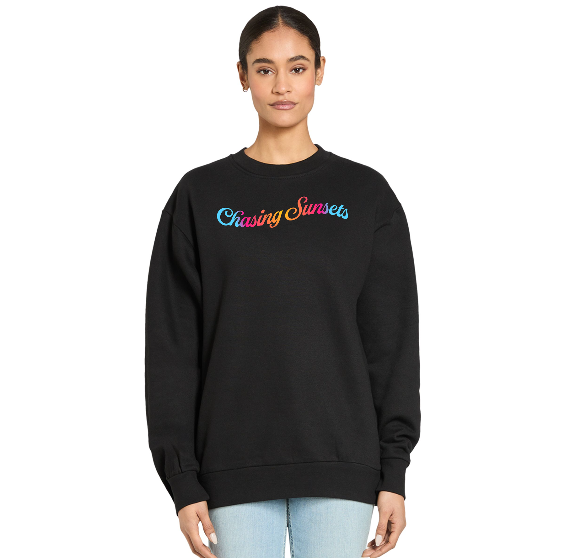 Black sweatshirt with 'Chasing Sunsets' text in colorful letters worn by a person on a white background