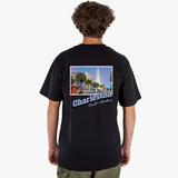 Person wearing a black t-shirt with a Charleston graphic on the back