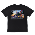 Black t-shirt with a colorful graphic of a city street and text on a white background