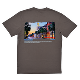 Gray t-shirt with a colorful graphic of a city street on the back