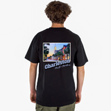 Person wearing a black t-shirt with 'Charleston, South Carolina' on the back