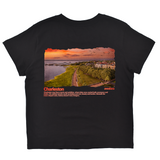 Black t-shirt with a scenic print of Charleston and text on a white background