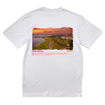 White t-shirt with a scenic print on the back and text on the front, displayed on a white background.