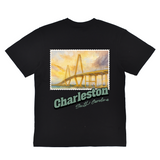 Black t-shirt with a bridge graphic and 'Charleston, South Carolina' text on a white background