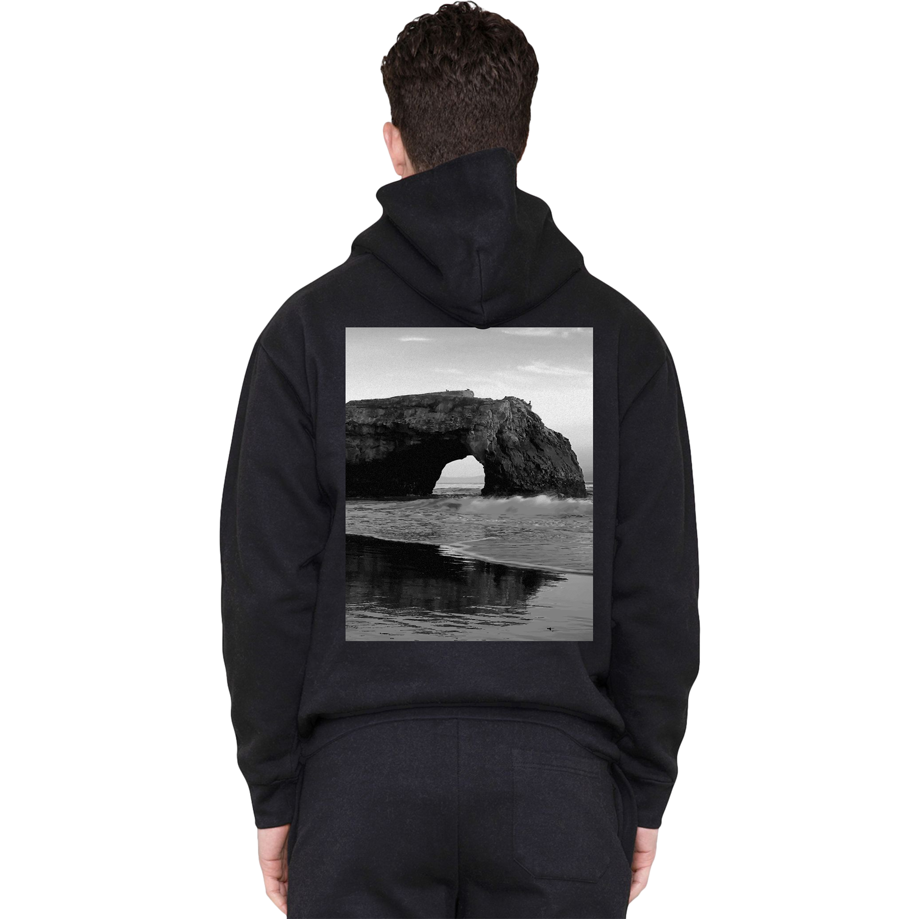 Person wearing a black hoodie with a scenic print on the back