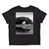 Black t-shirt with a graphic of a coastal arch on a white background