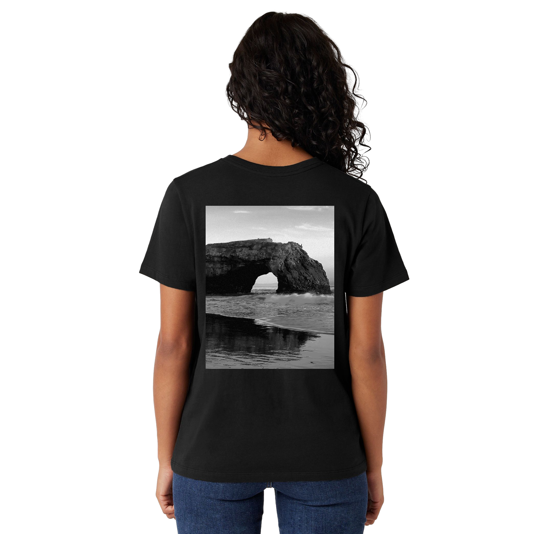 Person wearing a black t-shirt with a scenic print on the back