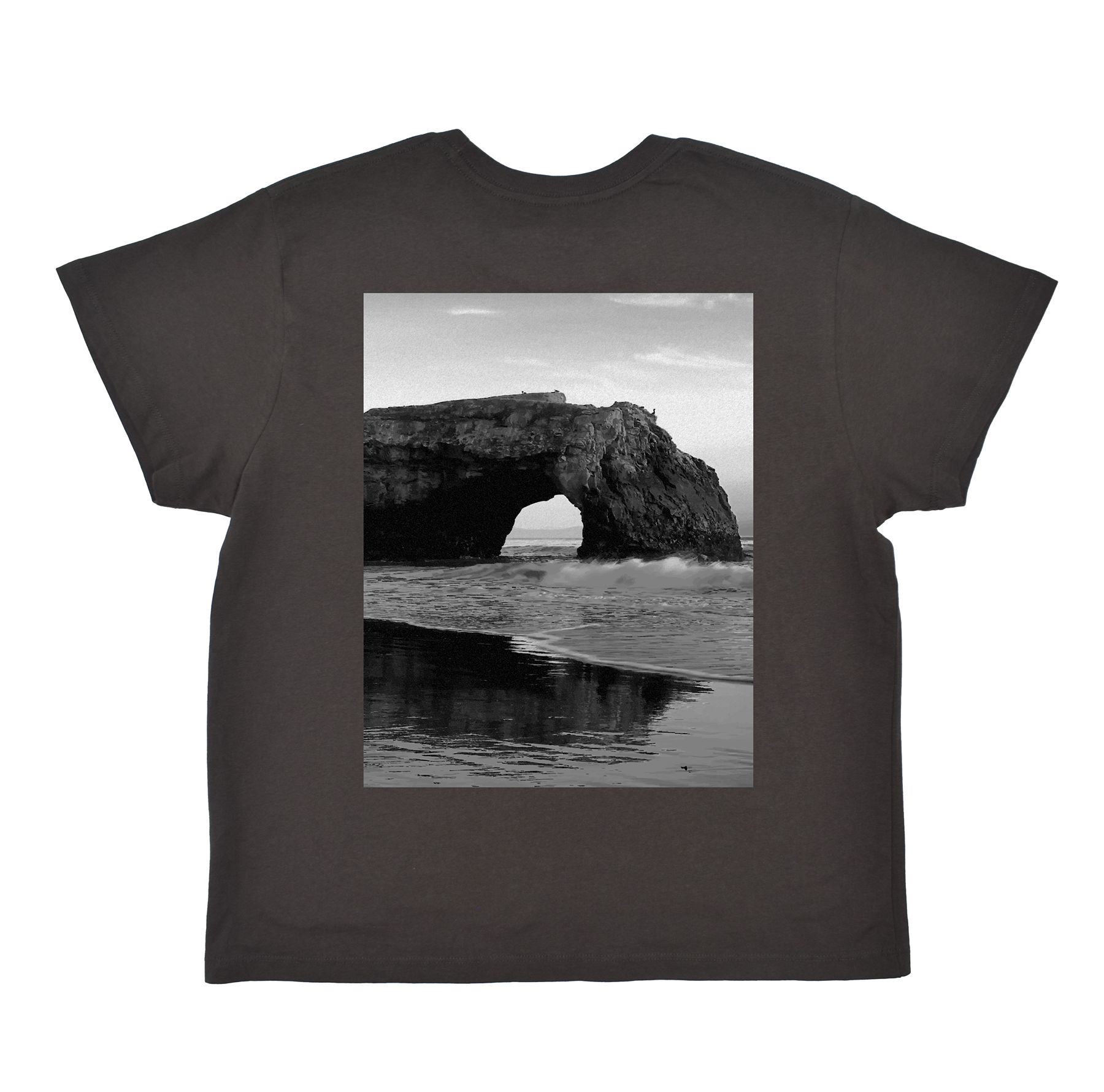 Black t-shirt with a black and white photo of a coastal arch on the front