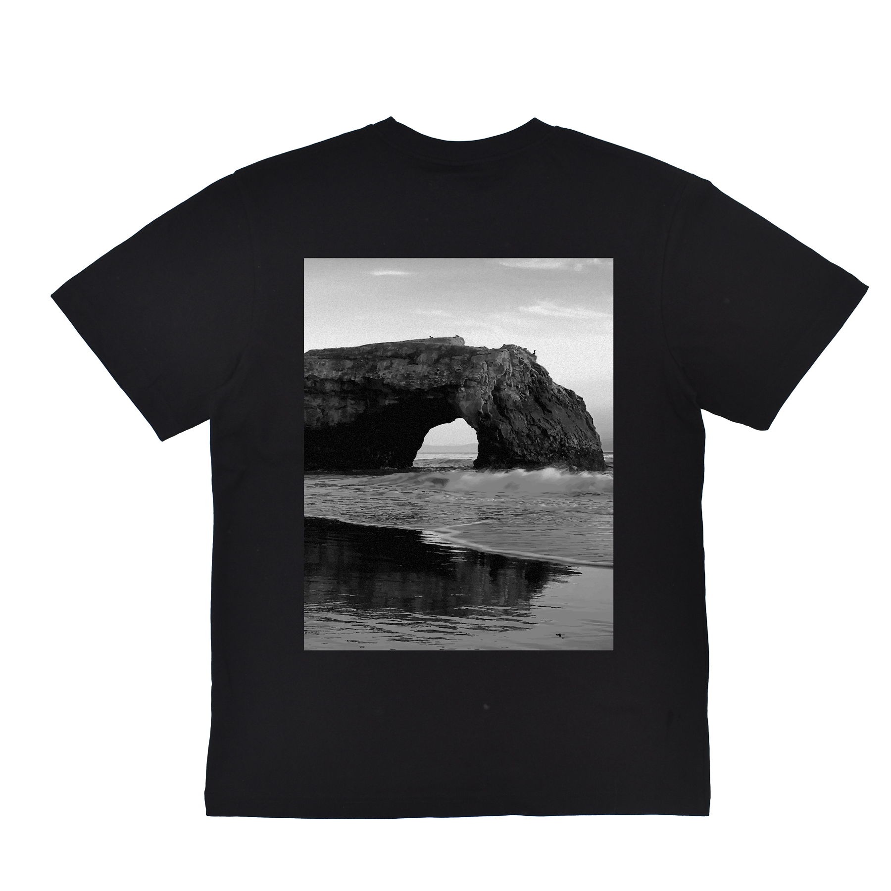 Black t-shirt with a scenic print of a rock arch over water on a white background