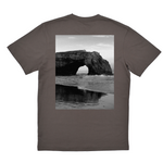 Gray t-shirt with a black and white photo of a coastal arch on the back