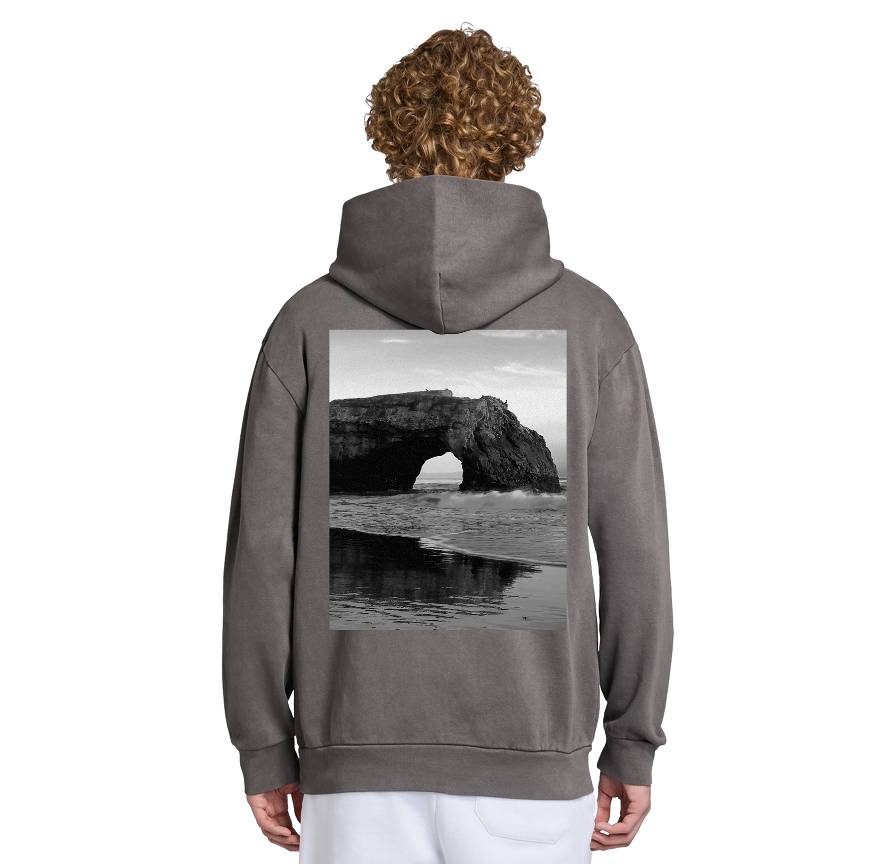 Person wearing a gray hoodie with a beach scene printed on the back