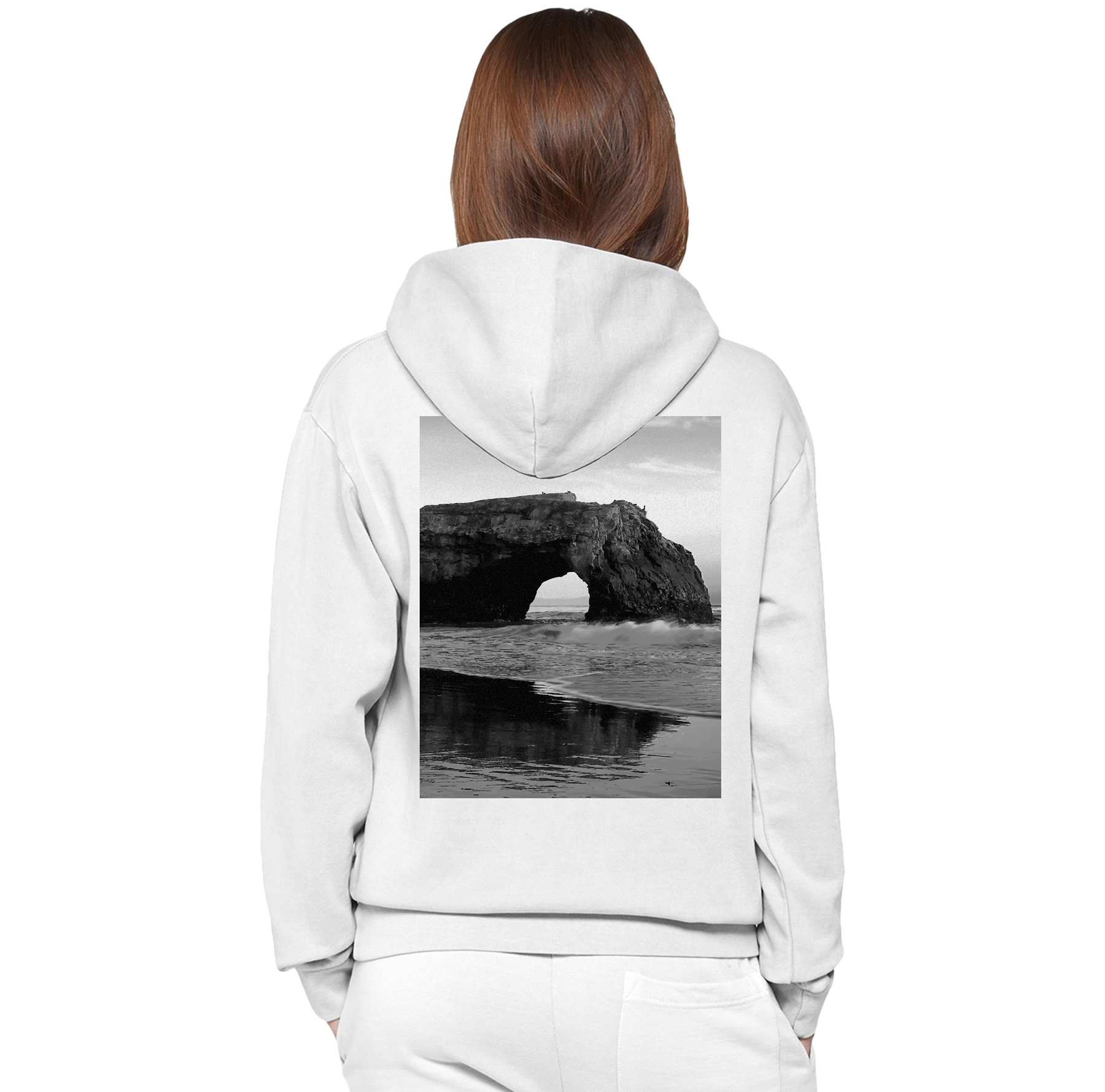 White hoodie with a black and white image of a natural arch on the back, worn by a person.