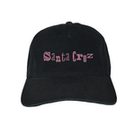 Black cap with pink 'Santa Cruz' text on a white background