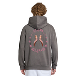 Person wearing a gray hoodie with a graphic design on the back against a white background