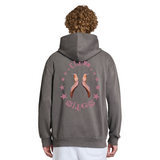 Person wearing a gray hoodie with a graphic design on the back against a white background